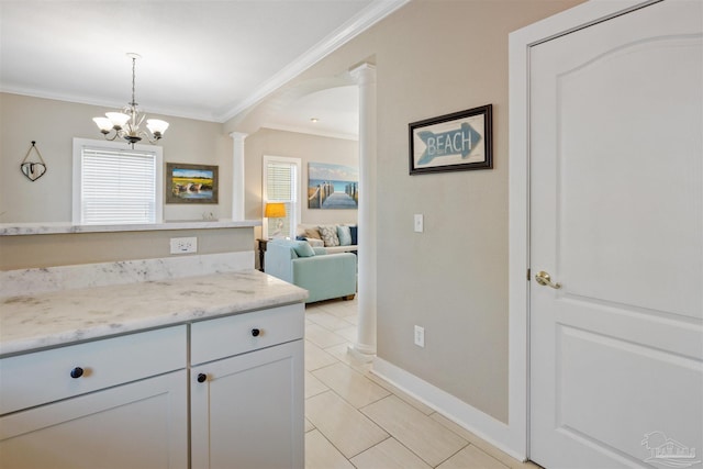 kitchen featuring a notable chandelier, light stone countertops, crown molding, and light tile patterned flooring