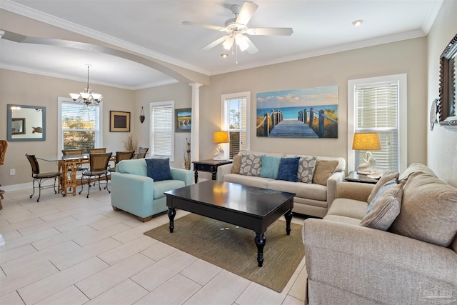 living room featuring crown molding, ceiling fan with notable chandelier, plenty of natural light, and decorative columns