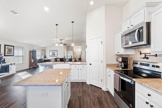 kitchen featuring visible vents, open floor plan, dark wood-type flooring, and stainless steel appliances