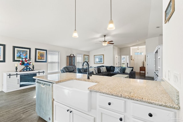 kitchen featuring pendant lighting, ceiling fan, a sink, dishwasher, and vaulted ceiling