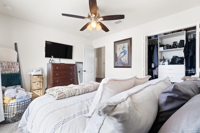 bedroom with visible vents, ceiling fan, and a closet