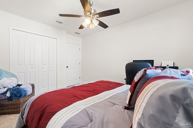 bedroom with carpet floors, ceiling fan, a closet, and visible vents
