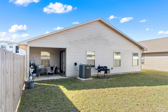 back of property featuring a yard, a patio, cooling unit, and fence