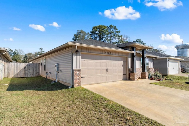 prairie-style house featuring a garage, fence, driveway, and a front yard