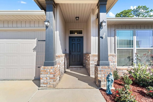 doorway to property with stone siding and a garage