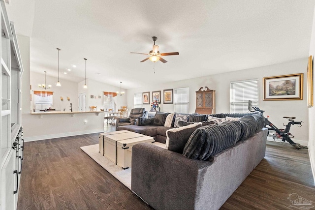 living room featuring baseboards, ceiling fan, vaulted ceiling, and dark wood-type flooring
