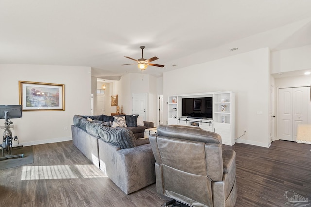 living room with baseboards, a ceiling fan, dark wood-style floors, and visible vents