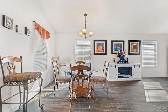 dining area with baseboards, dark wood finished floors, and a notable chandelier