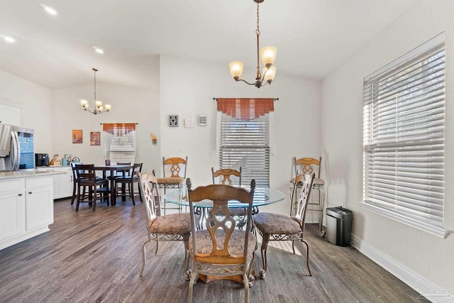 dining area featuring dark wood-type flooring, a chandelier, and a healthy amount of sunlight