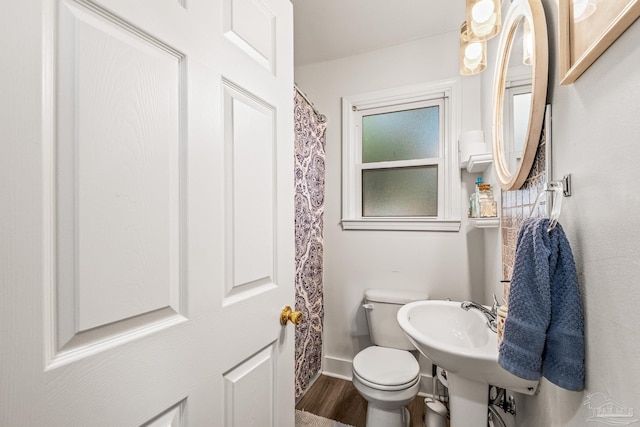 bathroom with toilet and hardwood / wood-style floors