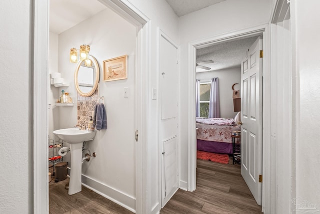 bathroom featuring a textured ceiling, hardwood / wood-style flooring, and sink