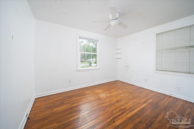 spare room with ceiling fan and dark wood-type flooring