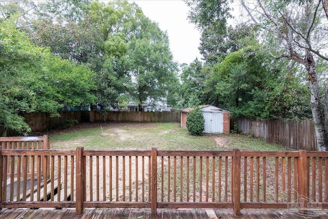 view of yard with a storage shed and a deck