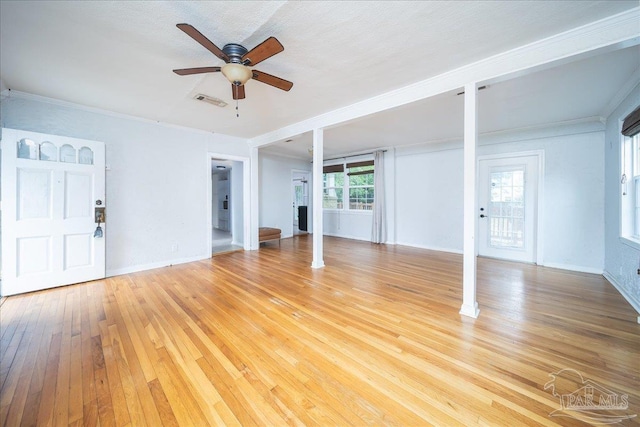 unfurnished living room with ceiling fan, plenty of natural light, light hardwood / wood-style floors, and a textured ceiling