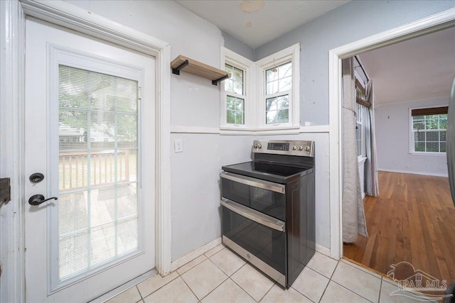 kitchen with light hardwood / wood-style flooring and stainless steel electric range