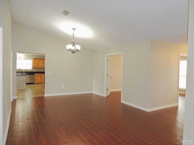 4814 Belvedere Cir, Pace, FL 32571 - unfurnished living room with a chandelier, vaulted ceiling, and dark wood-style floors