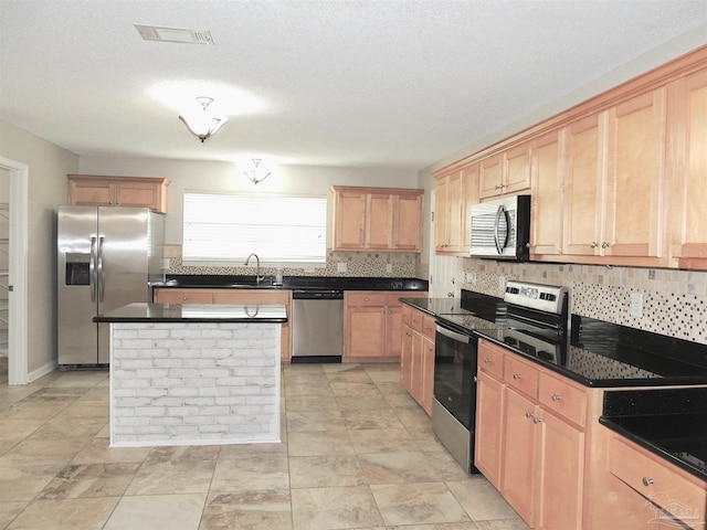 4814 Belvedere Cir, Pace, FL 32571 - kitchen featuring stainless steel appliances, decorative backsplash, light brown cabinetry, dark countertops, and a kitchen island