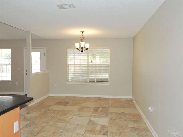 4814 Belvedere Cir, Pace, FL 32571 - unfurnished dining area with a chandelier and baseboards