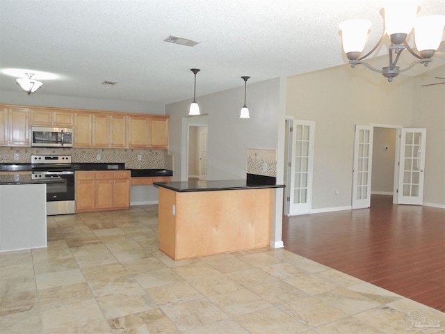 4814 Belvedere Cir, Pace, FL 32571 - kitchen featuring appliances with stainless steel finishes, decorative backsplash, dark countertops, french doors, and light brown cabinets