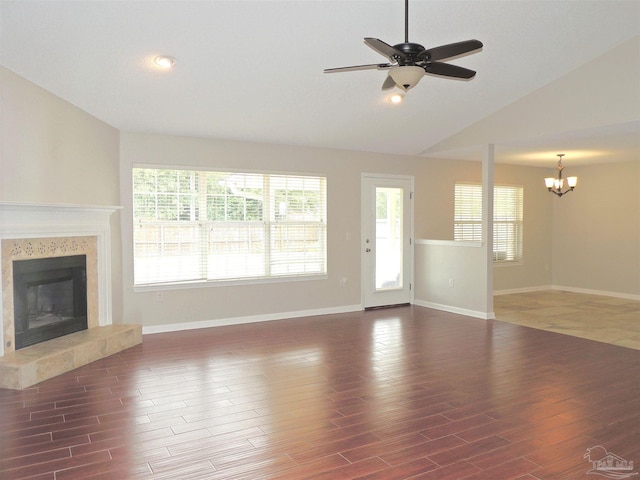 4814 Belvedere Cir, Pace, FL 32571 - unfurnished living room with a chandelier, a fireplace, wood finished floors, a ceiling fan, and healthy amount of natural light