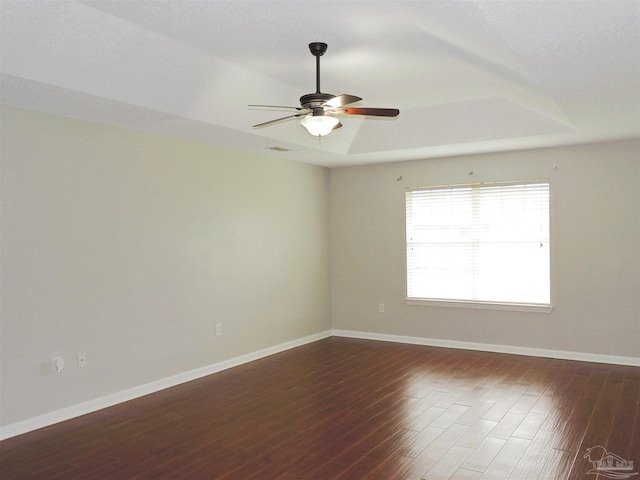 4814 Belvedere Cir, Pace, FL 32571 - unfurnished room with wood finished floors, a ceiling fan, and a tray ceiling