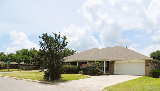 4814 Belvedere Cir, Pace, FL 32571 - view of front of property featuring brick siding, an attached garage, driveway, and a front lawn