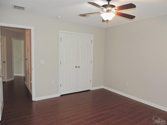 4814 Belvedere Cir, Pace, FL 32571 - unfurnished bedroom featuring dark wood-style floors, a closet, and ceiling fan