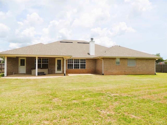 4814 Belvedere Cir, Pace, FL 32571 - rear view of house with a patio, a chimney, brick siding, and a shingled roof