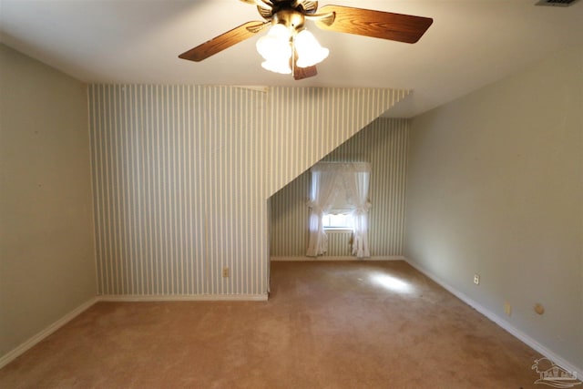 interior space featuring light colored carpet and ceiling fan