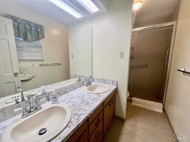 bathroom featuring toilet, vanity, tile patterned floors, and a shower with door