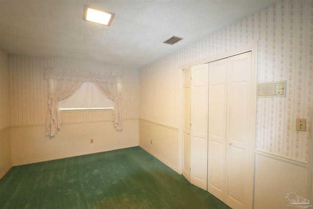 interior space featuring a textured ceiling and a closet