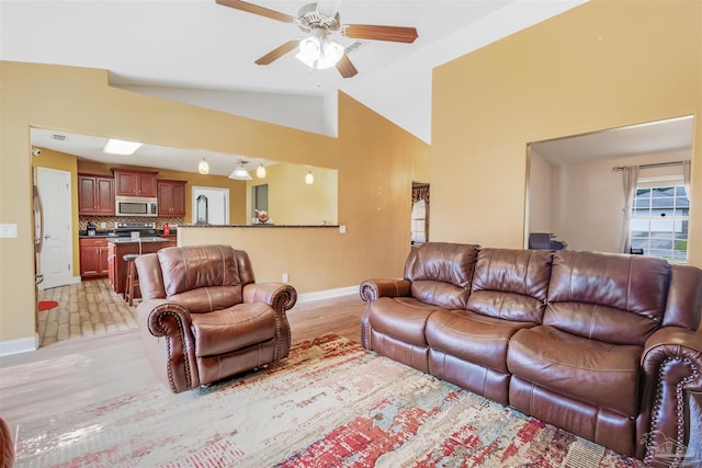 2546 Stormy Cir, Navarre, FL 32566 - living area with baseboards, a ceiling fan, light wood-style floors, and high vaulted ceiling