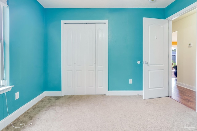2546 Stormy Cir, Navarre, FL 32566 - unfurnished bedroom featuring a closet, baseboards, and carpet flooring
