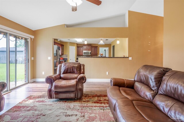 2546 Stormy Cir, Navarre, FL 32566 - living room featuring baseboards, a ceiling fan, light wood finished floors, and vaulted ceiling