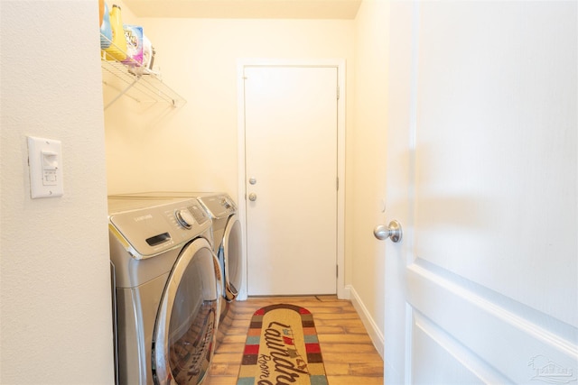 2546 Stormy Cir, Navarre, FL 32566 - laundry area with washing machine and clothes dryer, laundry area, and light wood finished floors