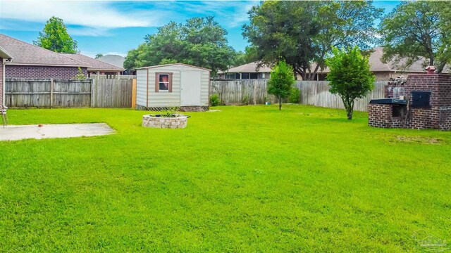 2546 Stormy Cir, Navarre, FL 32566 - view of yard featuring a storage unit, a fenced backyard, and an outbuilding