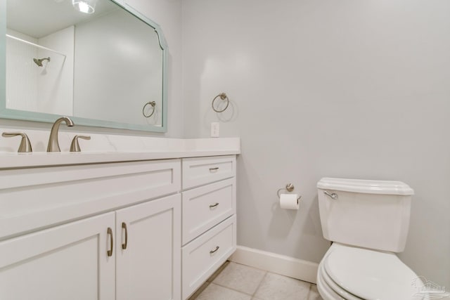 bathroom with a tile shower, tile patterned flooring, vanity, and toilet