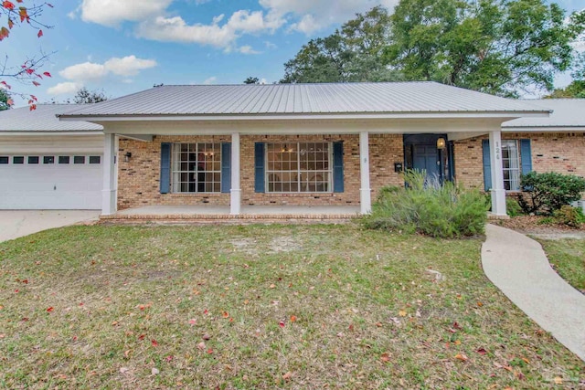 ranch-style house with a front lawn, covered porch, and a garage