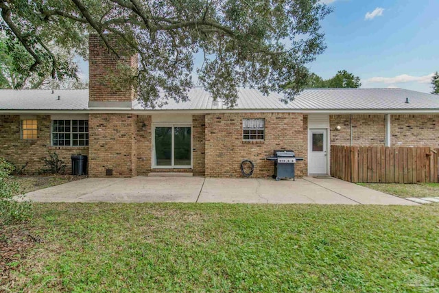 back of house with a patio area and a yard