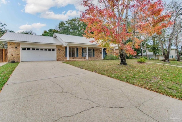 single story home featuring a front yard and a garage