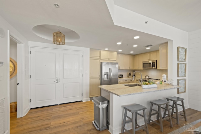 1 Portofino Dr Unit 709, Pensacola Beach, FL 32561 - kitchen featuring tasteful backsplash, a sink, light wood-style floors, stainless steel appliances, and a peninsula