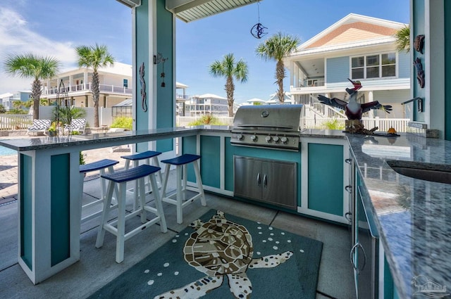 view of patio / terrace with exterior bar and area for grilling