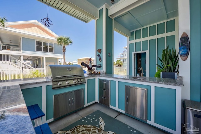 view of patio with area for grilling and sink