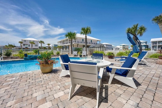 view of pool featuring pool water feature and a patio