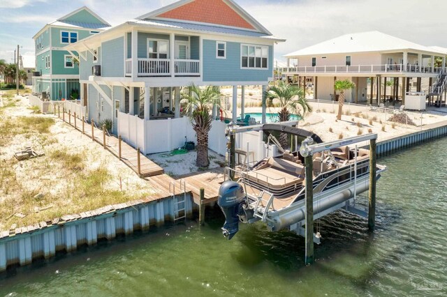 view of dock with a water view and a pool