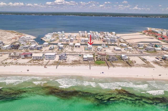 drone / aerial view featuring a beach view and a water view