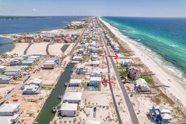 drone / aerial view featuring a beach view and a water view