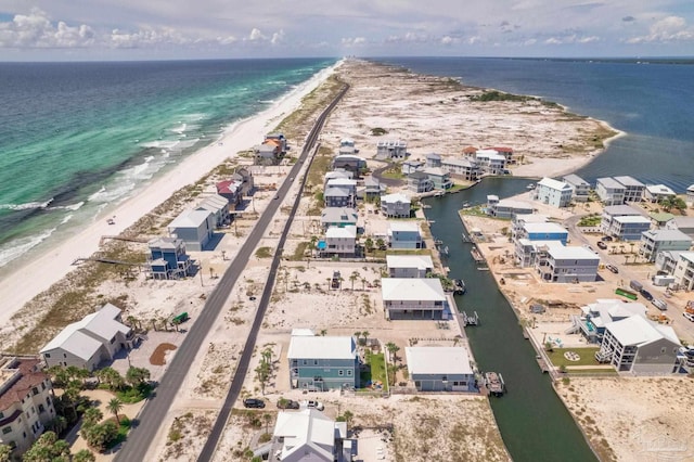 drone / aerial view with a beach view and a water view