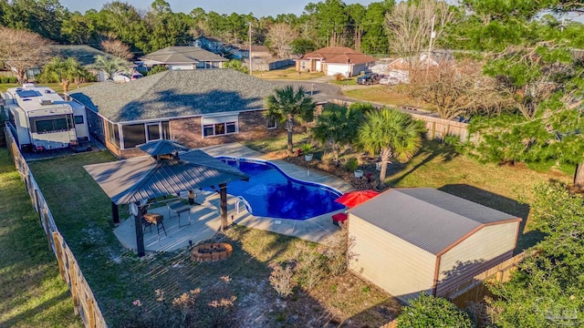 view of swimming pool featuring a fenced in pool, an outdoor fire pit, a fenced backyard, and a patio