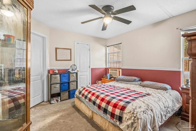 carpeted bedroom with a textured ceiling and ceiling fan